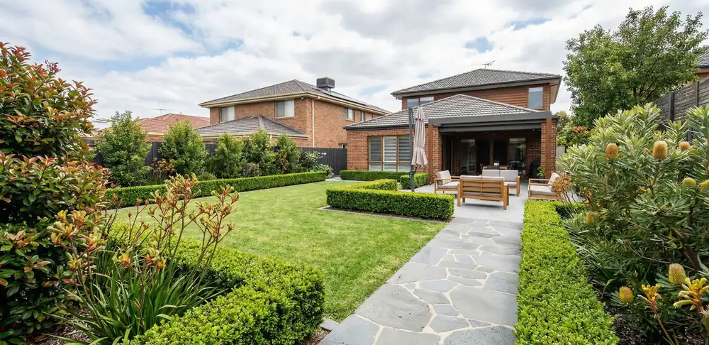 Professional landscaping project in Rowville Melbourne featuring garden design, lawn area, stone pathway and outdoor seating